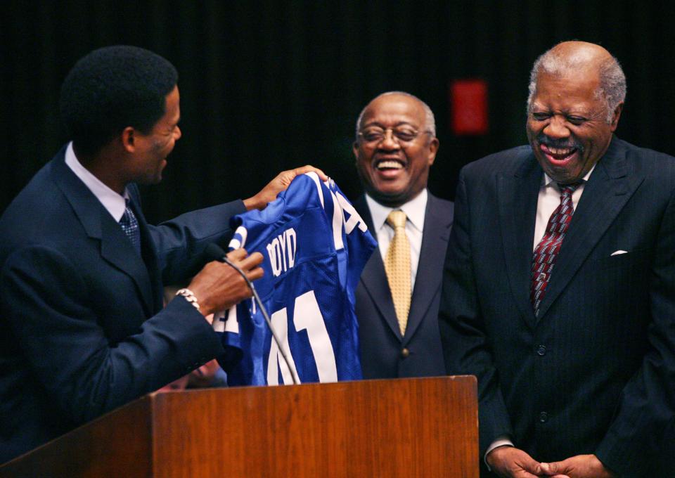 City-County Councilman Rozelle Boyd, a former council president, right, laughs heartily as Bill Brooks, representing the Indianapolis Colts owner Jim Irsay, presents a Colts jersey to him in appreciation for his 42 years of service on the council on Monday, December 17, 2007. The joviality was on account of the jersey number, 41, which was supposed to represent Boyd's council tenure. Councilman Duke Oliver is in the background.