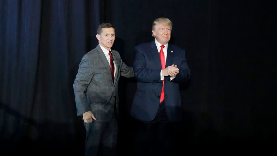 In this September 29, 2016, file photo, retired Gen. Michael Flynn, left, introduces then-Republican presidential candidate Donald Trump at a campaign rally, in Bedford, New Hampshire. - John Locher/AP/FILE