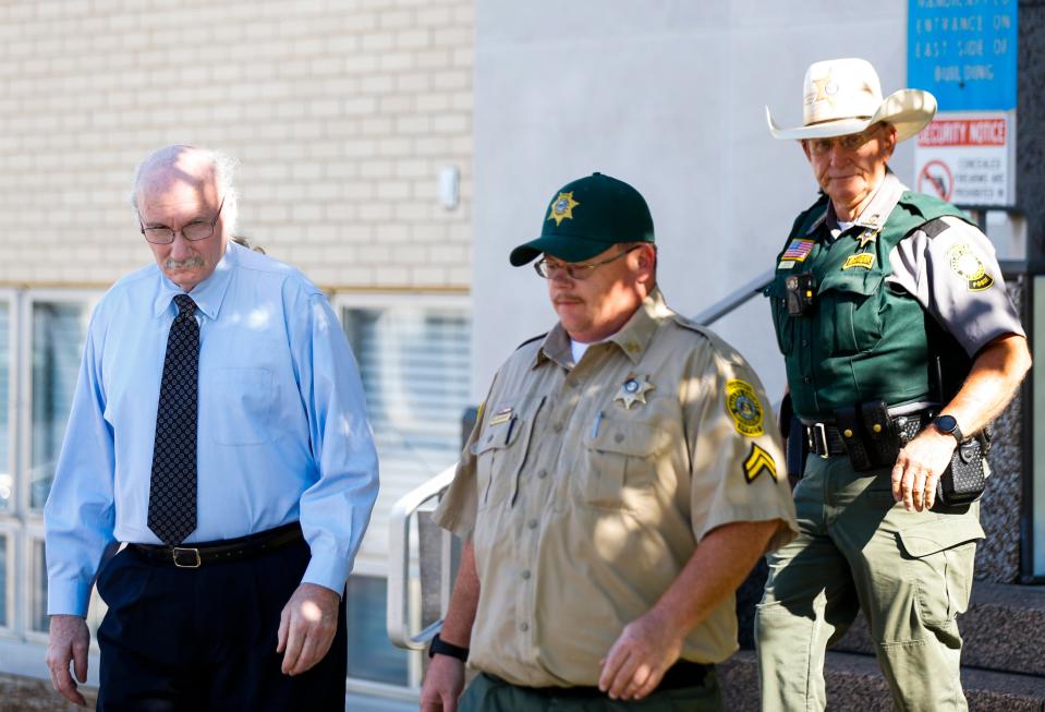 James Phelps (left) is escorted by two Dallas County Sheriff's deputies as he leaves the Dallas County Courthouse after waiving his right to a preliminary hearing on Thursday, July 14, 2022. 