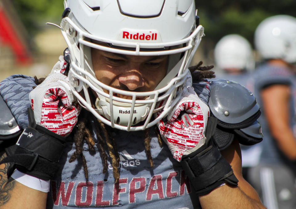 Western Oregon linebacker Isaiah Abraham adjusts his helmet during an NCAA college football practice, Wednesday, Aug. 9, 2023, in Monmouth, Ore. As one of just two NCAA Division II schools with football teams on the West Coast, Western Oregon spends hundreds of thousands of dollars in travel expenses to compete in the Lone Star Conference against schools in Texas and New Mexico. (AP Photo/Tim Booth)