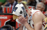 Wisconsin guard Brad Davison sits on the bench with a towel over his face during the second half of a first-round game against Oregon in the NCAA men’s college basketball tournament Friday, March 22, 2019, in San Jose, Calif. (AP Photo/Chris Carlson)