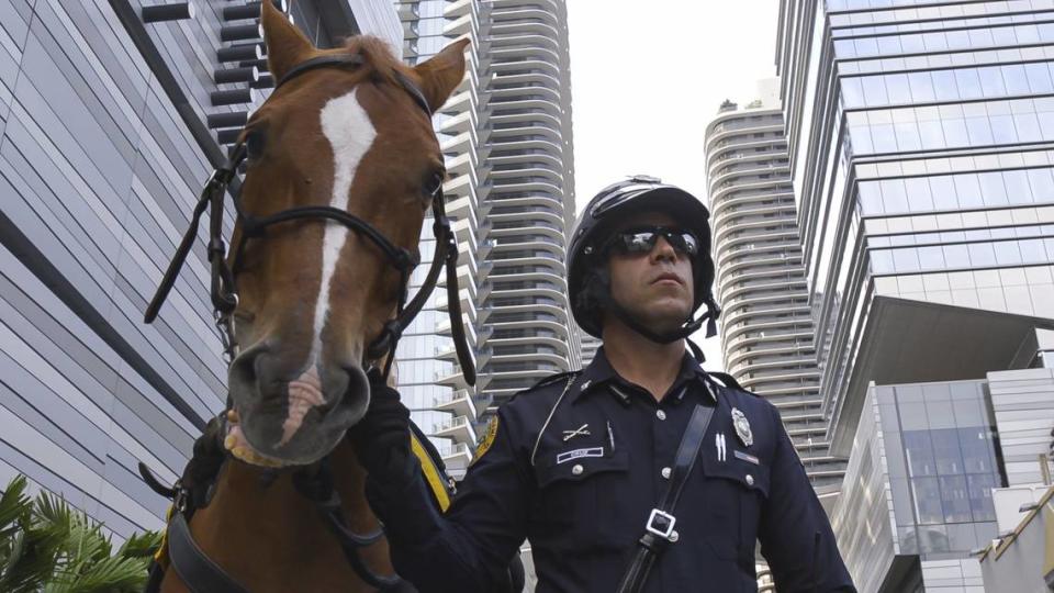 City of Miami Officer Loisel Cruz patrols next to his horse, Ike, in Brickell, Florida on Friday, April 17, 2020.