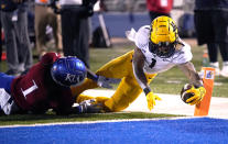 West Virginia wide receiver Winston Wright Jr. (1) dives into the end zone for a touchdown against Kansas safety Kenny Logan Jr. (1) during the second quarter of an NCAA college football game Saturday, Nov. 27, 2021, in Lawrence, Kan. (AP Photo/Ed Zurga)