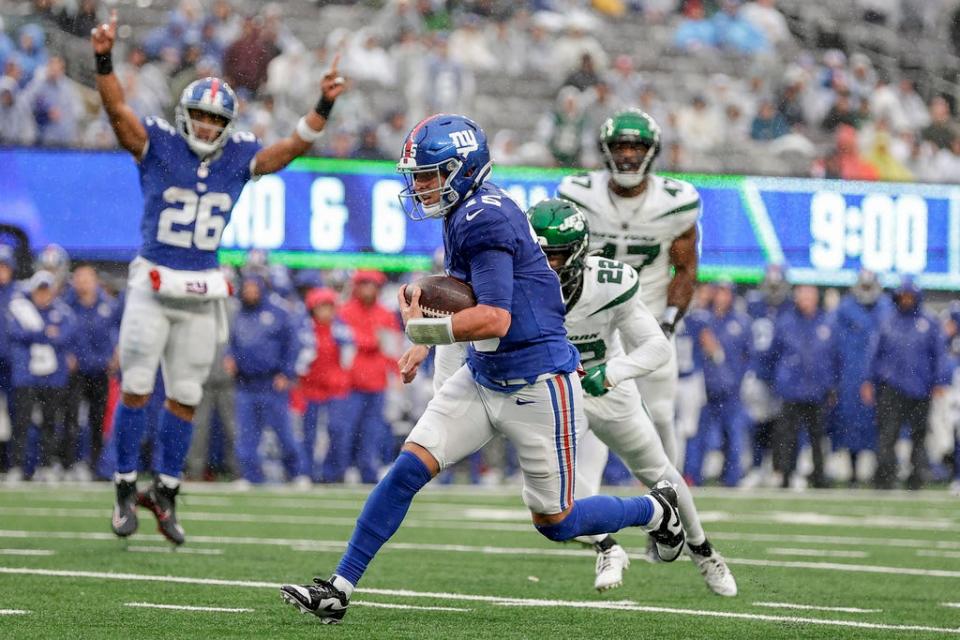 New York Giants quarterback Tommy DeVito (15) runs in a touchdown during the second half of an NFL football game against the New York Jets, Sunday, Oct. 29, 2023, in East Rutherford, N.J. (AP Photo/Adam Hunger)