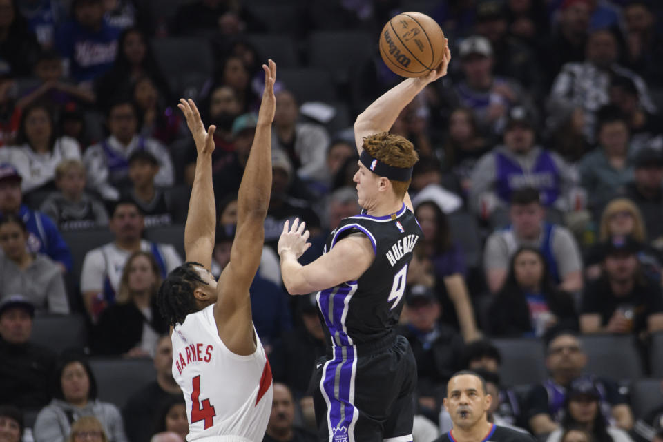 Sacramento Kings guard Kevin Huerter (9) looks to shoot over Toronto Raptors forward Scottie Barnes (4) during the first quarter of an NBA basketball game in Sacramento, Calif., Friday, Jan. 5, 2024. (AP Photo/Randall Benton)