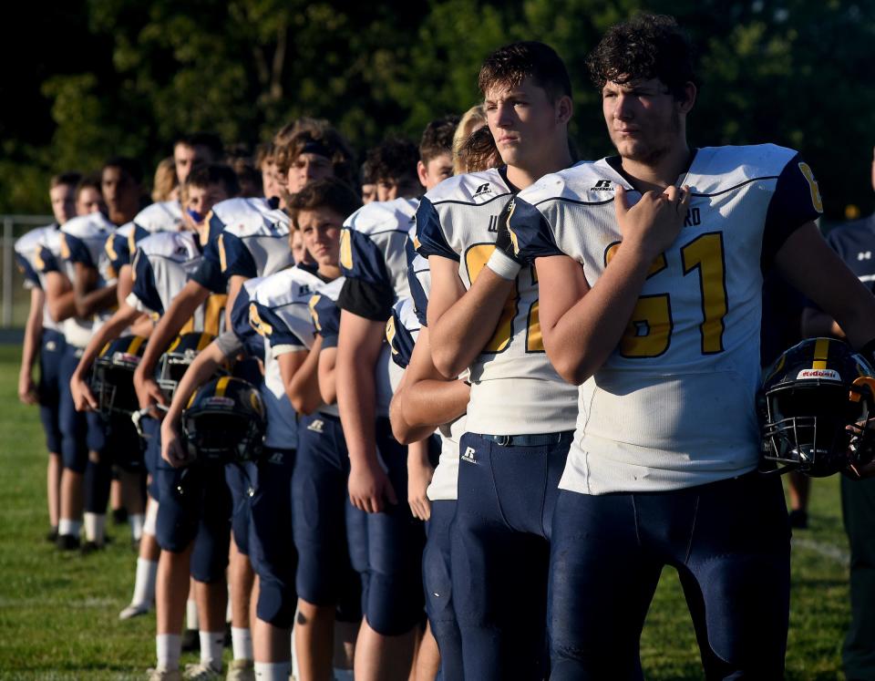 Whiteford football players stand for the national anthem.