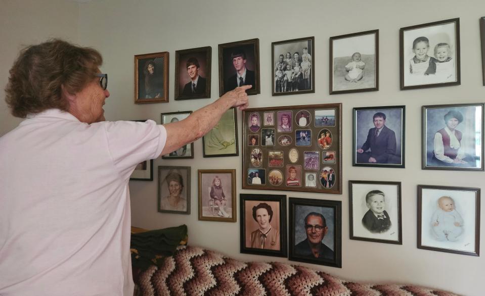 Iolene Powell shows off her picture wall of her family, including her mother and father.