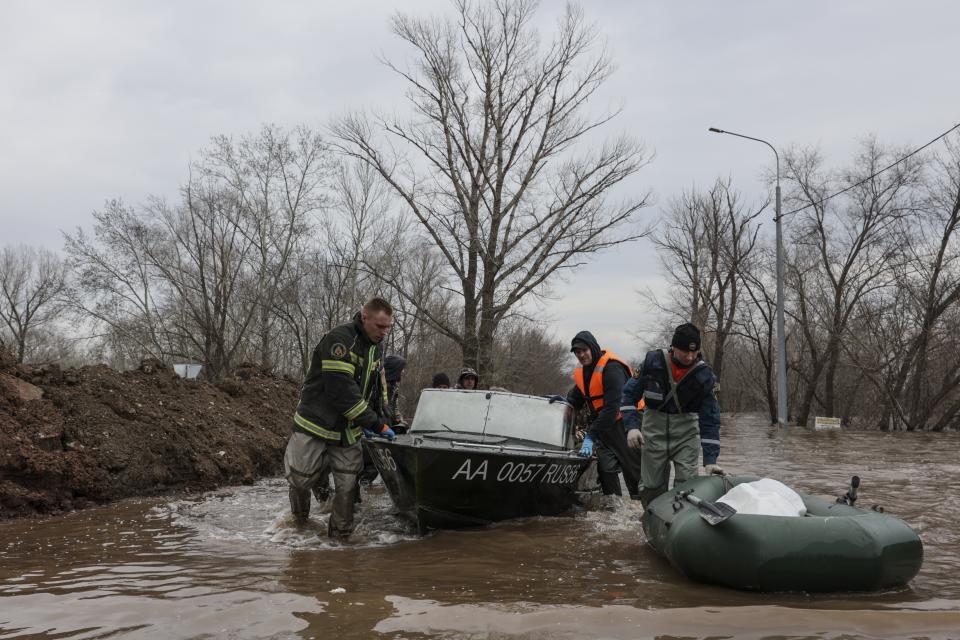 Emergency workers push their boats in a flooded area in Orenburg, Russia, Wednesday, April 10, 2024. Russian officials are scrambling to help homeowners displaced by floods, as water levels have risen in the Ural River. The floods in the Orenburg region near Russia's border with Kazakhstan sparked the evacuation of thousands of people following the collapse of a dam on Saturday. (AP Photo)