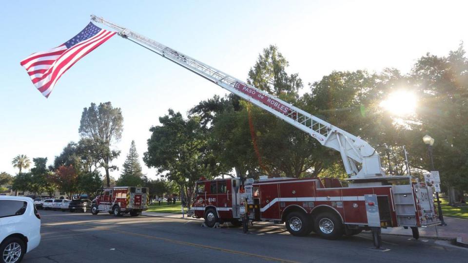 The American flag waves from a Paso Robles Fire Department truck as more than 100 people gathered to remember late Mayor Steve Martin at Downtown City Park on Sept. 27, 2023.