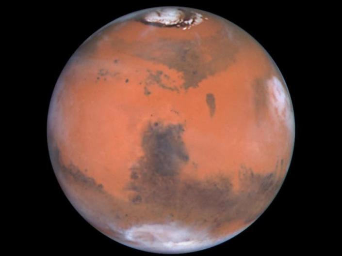 mars planète rouge avec des taches brunes et des calottes polaires blanches