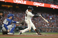 San Francisco Giants' Buster Posey hits a double in front of Los Angeles Dodgers catcher Will Smith during the first inning of Game 5 of a baseball National League Division Series Thursday, Oct. 14, 2021, in San Francisco. (AP Photo/Jed Jacobsohn)