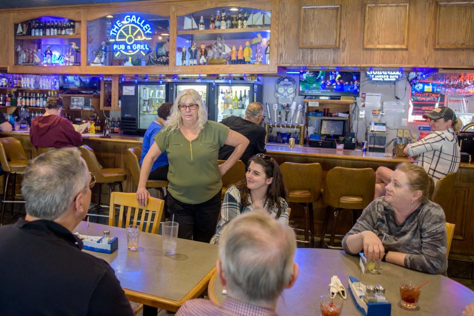 Vicki Love-Freeman, owner of The East Port Galley Restaurant and Pub, chats with customers Thursday, April 27, 2023 at the business in East Peoria.