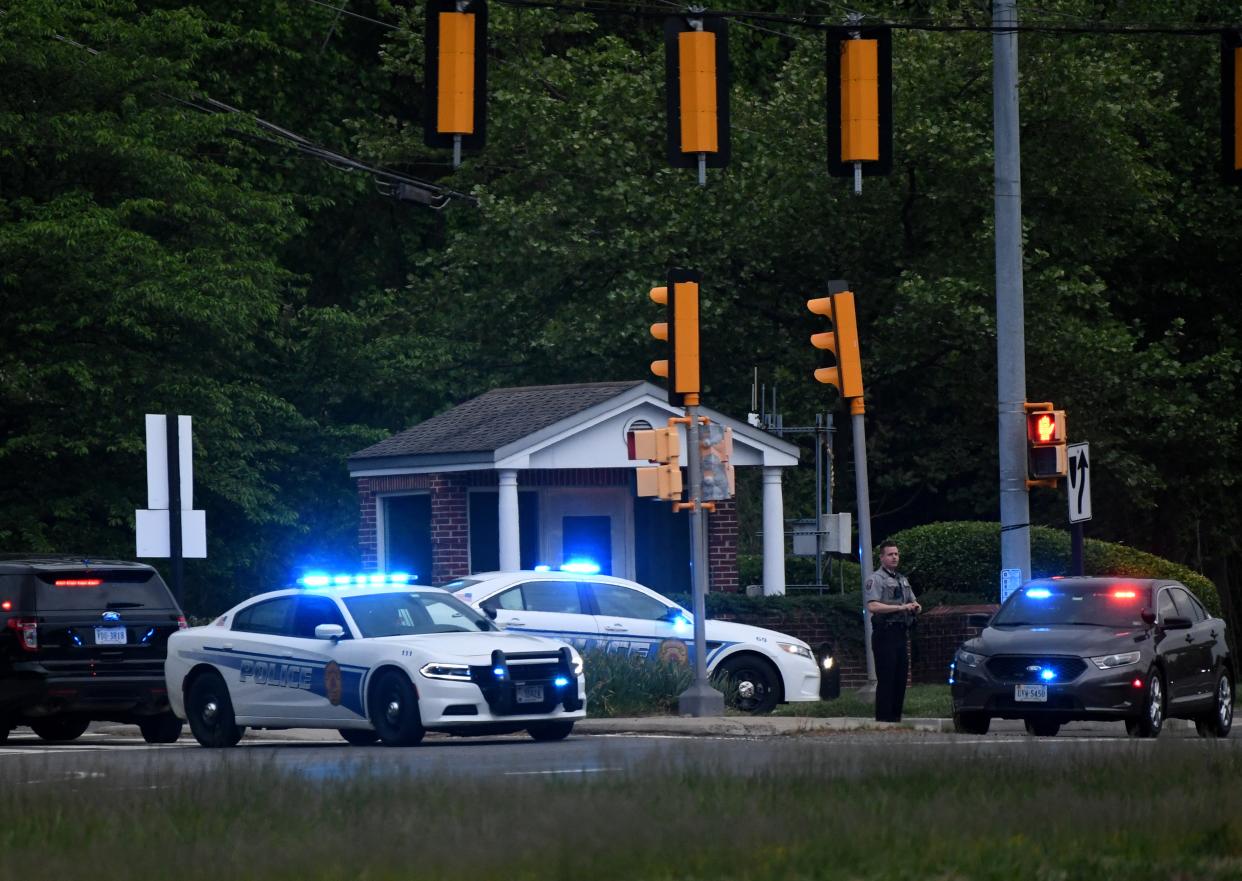 <p>Police cars are seen outside the CIA headquarters's gate after an attempted intrusion earlier in the day in Langley, Virginia, on May 3, 2021</p> (Photo by OLIVIER DOULIERY/AFP via Getty Images)