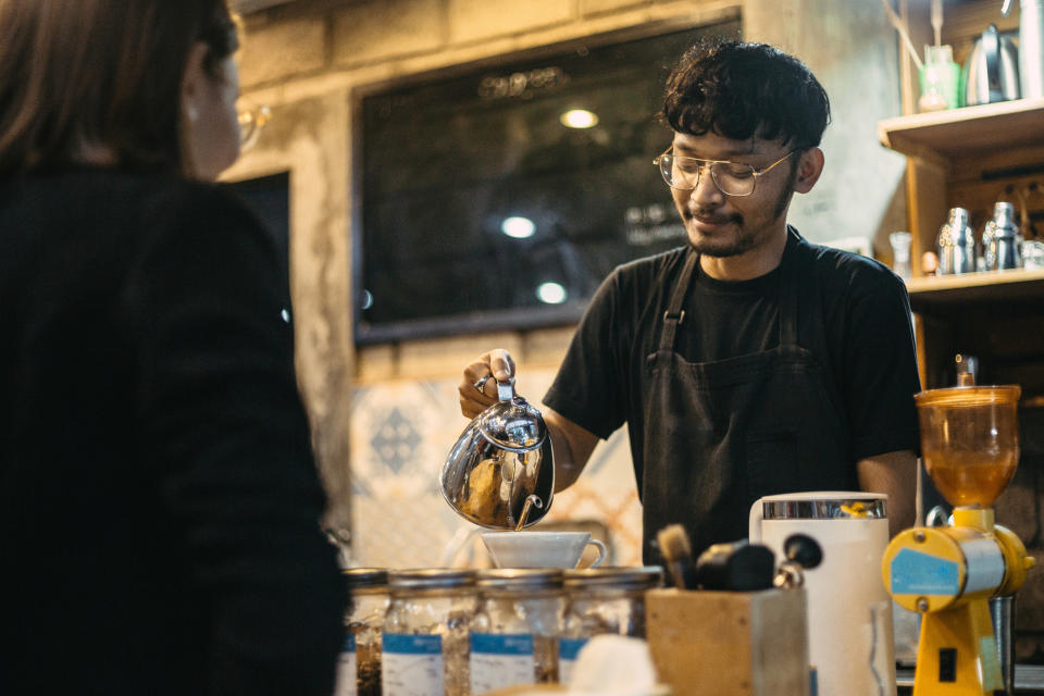 A barista pouring coffee