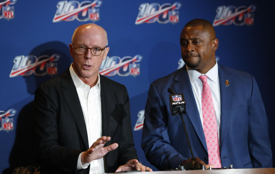 Atlanta Falcons president and CEO Rich McKay, left, a member of the NFL competition committee, speaks as NFL executive vice president Troy Vincent, right, looks on during a news conference at the NFL Fall League Meeting, Tuesday, Oct. 15, 2019 in Fort Lauderdale, Fla. NFL owners begin two days of meetings Tuesday with formal bargaining talks on a new collective bargaining agreement expected to resume soon. (AP Photo/Wilfredo Lee)
