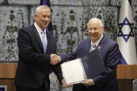 Israeli President Reuven Rivlin hands a mandate to form new government to Blue and White Party leader Benny Gantz in Jerusalem, Wednesday, Oct. 23, 2019. (AP Photo/Sebastian Scheiner)