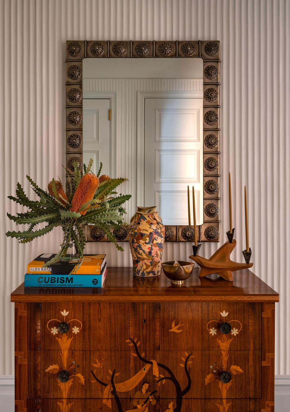 “The walls aren’t striped, they’re actually hand-applied fluted Venetian plaster,” says Rockwell, who teamed up with Kamp Studios on this statement for the entryway, which he decorated with a 1960s Italian aluminum mirror from John Salibello and a 1940s Swedish chest of drawers from England, topped with a ceramic work by Cody Hoyt from Patrick Parrish.