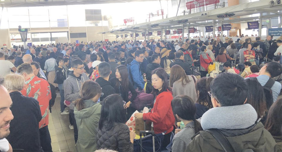 Crowds gather in Sydney Airport as strong winds cause flight cancellations and lengthy delays. Source: Twitter/lenman74