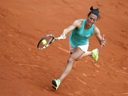 Francesca Schiavone of Italy plays a shot to Svetlana Kuznetsova of Russia during their women's singles match at the French Open tennis tournament at the Roland Garros stadium in Paris, France, May 28, 2015. REUTERS/Gonzalo Fuentes