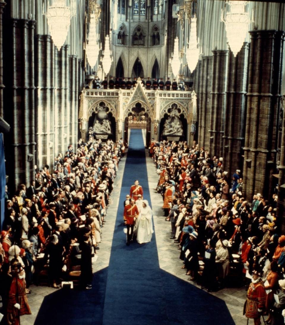 Princess Anne and Captain Mark Phillips walk down the aisle at Westminster Abbey during their wedding on November 14, 1973.