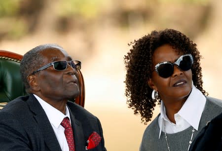 FILE PHOTO: Zimbabwe's former president Robert Mugabe and his wife Grace look on after addressing a news conference at his private residence nicknamed "Blue Roof" in Harare