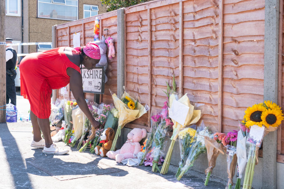 A woman lays flowers near Galpin's Road in Thornton Heath, south London. The London Ambulance Service has confirmed a child has died and three people are in hospital after the terraced home collapsed following an explosion and fire on Monday. Picture date: Tuesday August 9, 2022.