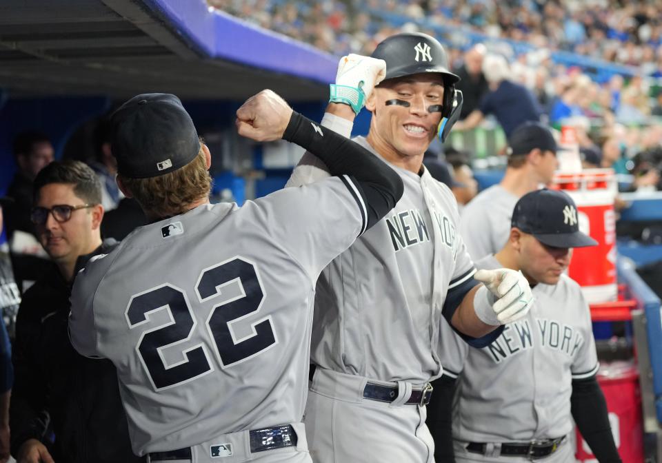 Yankees slugger Aaron Judge celebrates his second home run of the game with fellow outfielder Harrison Bader in Monday's 7-4 win over the Blue Jays.