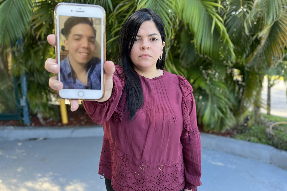 Venezuelan immigrant Carolina Estrada shows a photo of her son Ricardo, 22, the only member of the family to be deported by ICE after requesting asylum. (Damia Bonmati / Telemundo)