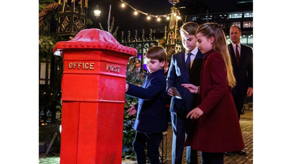 Prince Louis, Prince George and Princess Charlotte post letters at the Royal Carols concert