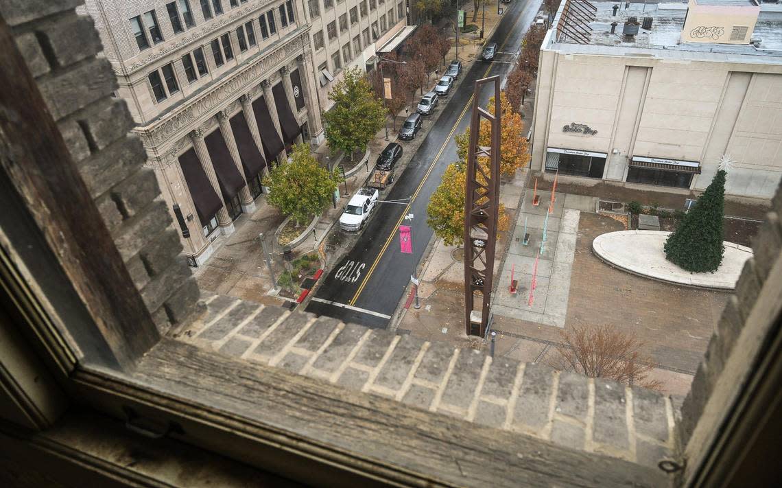 The historic Fulton Clock Tower in downtown Fresno’s Mariposa Plaza comes into view out the window of an eighth floor window of the historic Helm Building on Thursday, Dec. 1, 2022. Sevak Khatchadourian, who has successfully renovated the Pacific Southwest Building, is hoping to develop the Helm Building with new micro apartments.