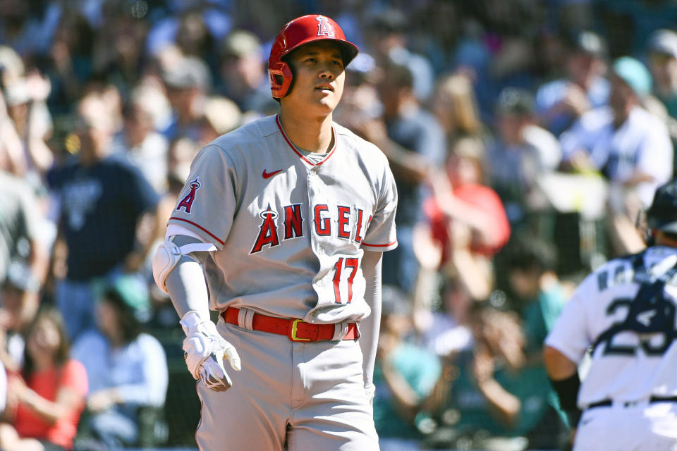 Los Angeles Angels designated hitter Shohei Ohtani reacts after being struck out during the seventh inning of a baseball game against the Seattle Mariners, Saturday, Aug. 6, 2022, in Seattle. (AP Photo/Caean Couto)
