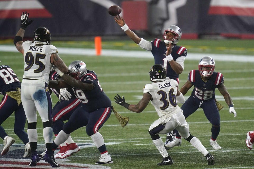 New England Patriots quarterback Cam Newton passes under pressure from Baltimore Ravens defensive end Derek Wolfe (95) and safety Chuck Clark (36) in the first half of an NFL football game, Sunday, Nov. 15, 2020, in Foxborough, Mass. (AP Photo/Elise Amendola)