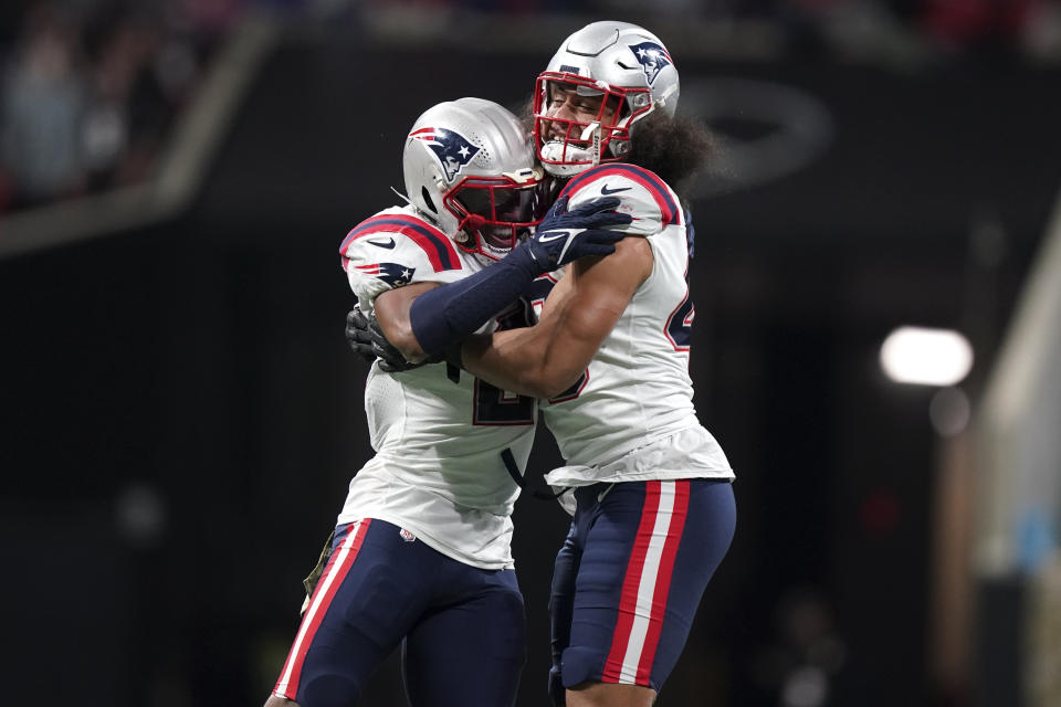 New England Patriots linebacker Jahlani Tavai (48) and New England Patriots safety Adrian Phillips (21) celebrate a defense of stop of the Atlanta Falcons during the second half of an NFL football game, Thursday, Nov. 18, 2021, in Atlanta. (AP Photo/Brynn Anderson)