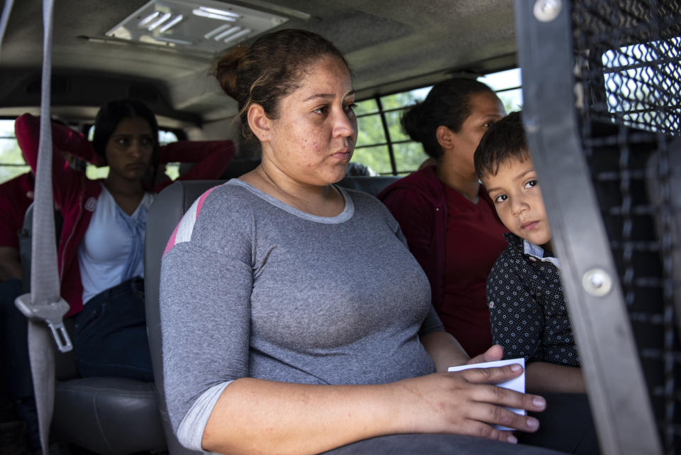 Illegal immigrants are loaded into a van after being detained 