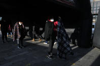 Residents wait to be tested at a COVID testing center in Quito, Ecuador, Tuesday, Jan. 11, 2022. The provincial government center is offering low-cost COVID PCR tests as an upsurge in infections is feared following the holiday season. (AP Photo/Dolores Ochoa)