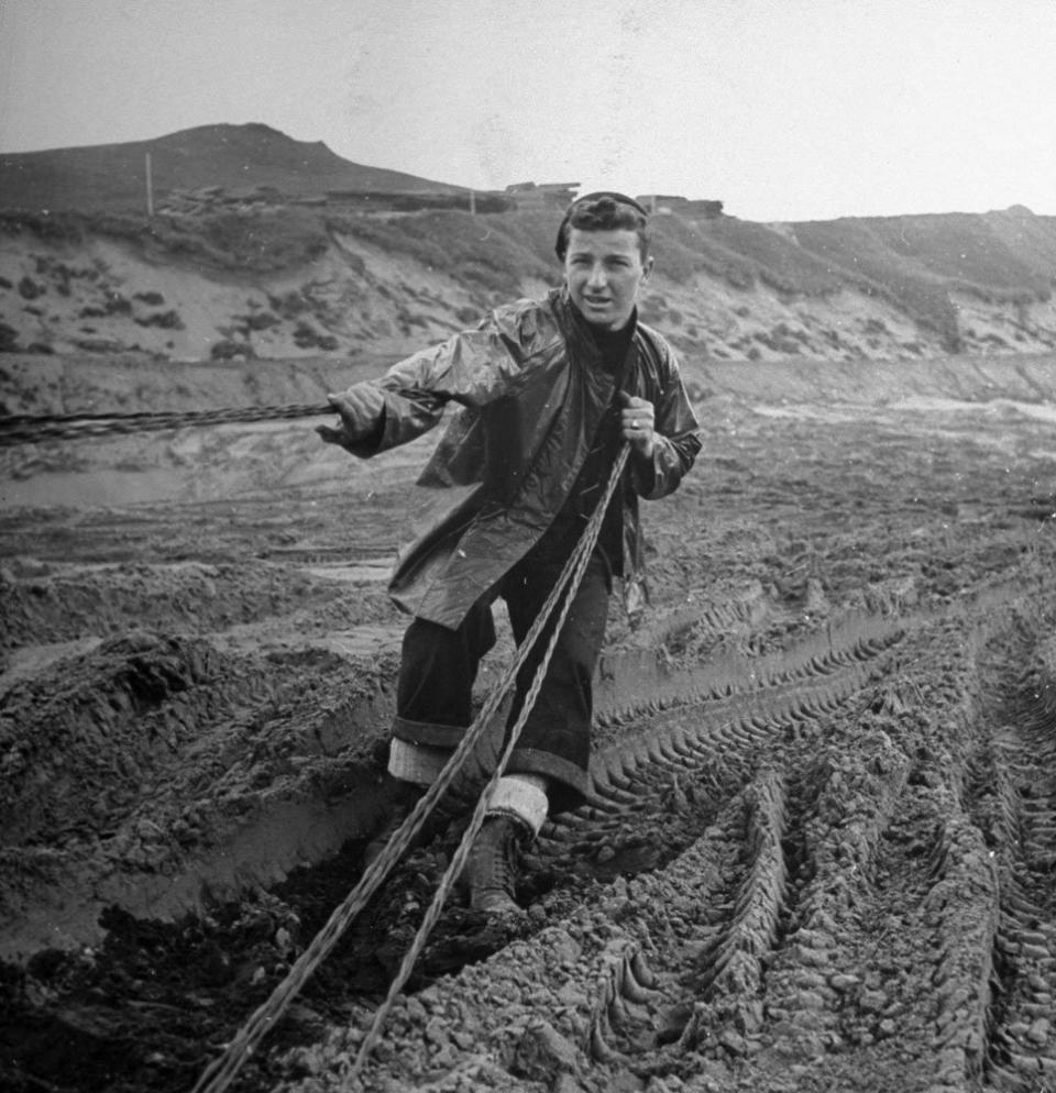 A Seabee (of the U.S. Navy's Construction Battalion) strings wire for communications on the island of Adak, Aleutian Campaign, Alaska, 1943.