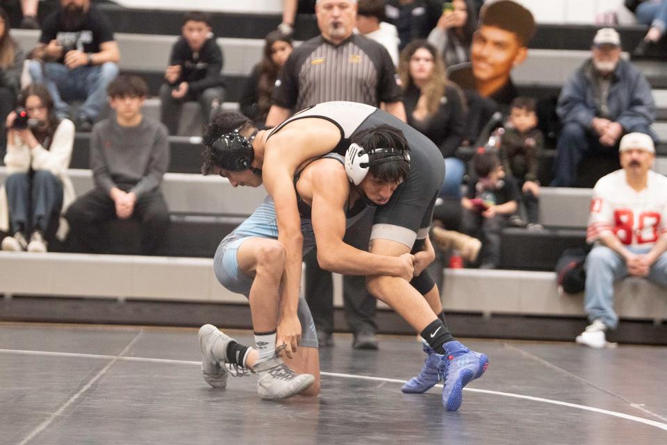 Pueblo West's Eleazar Bachicha shoots in for a takedown on Pueblo South's David Carillo during their 106-pound match on Wednesday, January 24, 2024.
