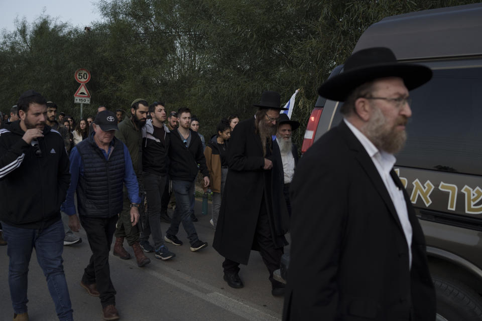 Relatives and friends of the Israeli Captain Neriya Zisk, follow his funeral procession as they arrive at a cemetery in the village of Masu'ot Yitzhak, Israel, Thursday, Dec. 28, 2023. Zisk was killed in combat in the Gaza Strip. (AP Photo/Leo Correa)