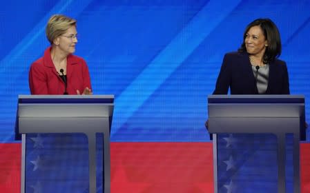 Senator Elizabeth Warren and Senator Kamala Harris smile at each other during the 2020 Democratic U.S. presidential debate in Houston