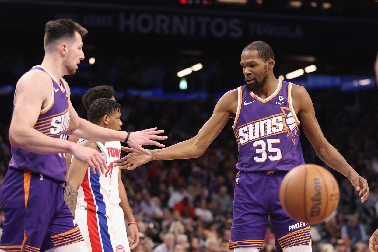 Suns forward Kevin Durant high-fives center Drew Eubanks after scoring against the Pistons during the first half on Wednesday, Feb. 14, 2024, in Phoenix.