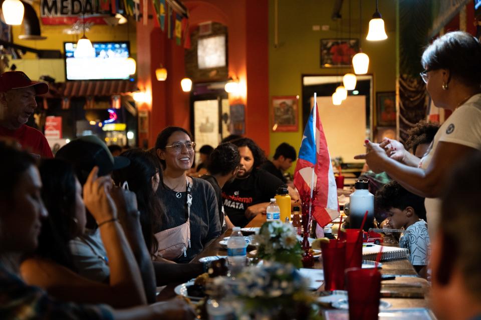 A group of people gather at Puerto Rico Latin Bar & Grill to organize fundraising efforts for Puerto Rico after Hurricane Fiona, Friday, Sept. 23, 2022.