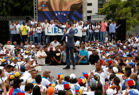 Venezuelan opposition leader Juan Guaido, who many nations have recognised as the country's rightful interim ruler, speaks during a swearing-in ceremony for supporters in Caracas, Venezuela April 27, 2019. REUTERS/Carlos Garcia Rawlins