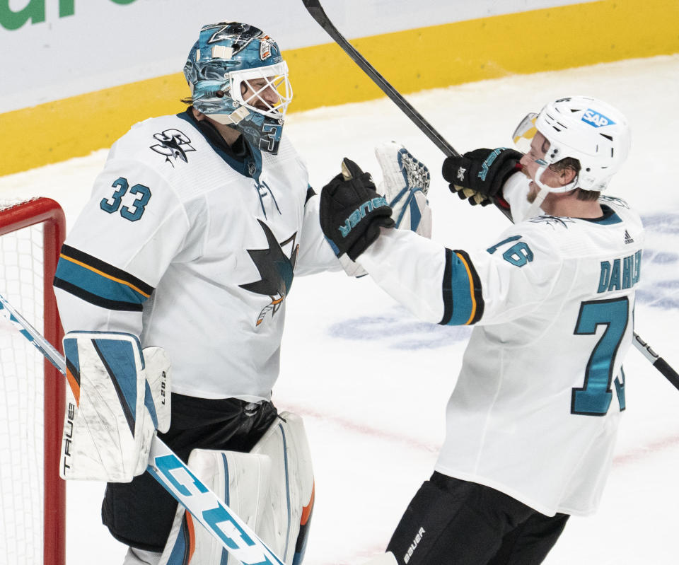 San Jose Sharks goaltender Adin Hill (33) celebrates with Jonathan Dahlen (76) after shutting out the Montreal Canadiens in an NHL hockey game Tuesday, Oct. 19, 2021, in Montreal. (Ryan Remiorz/The Canadian Press via AP)