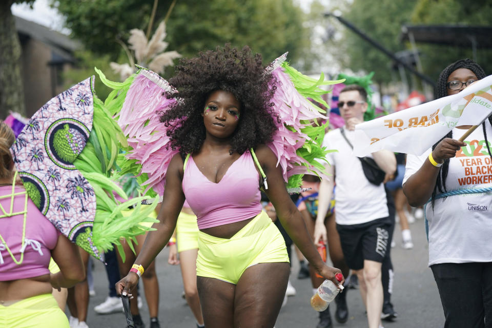 People participate in the Children's Day Parade, part of the Notting Hill Carnival celebration in west London, Sunday, Aug. 27, 2023. (Yui Mok/PA via AP)