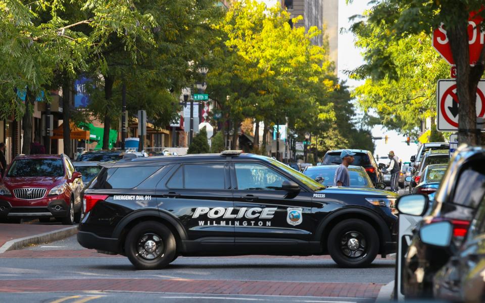 A Wilmington police vehicle moves across Market Street in downtown Wilmington, Tuesday, Sept. 19, 2023.