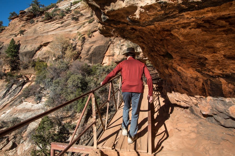 A hiker walks along the precarious trail in Zion National Park. (credit: George Rose/Getty Images)