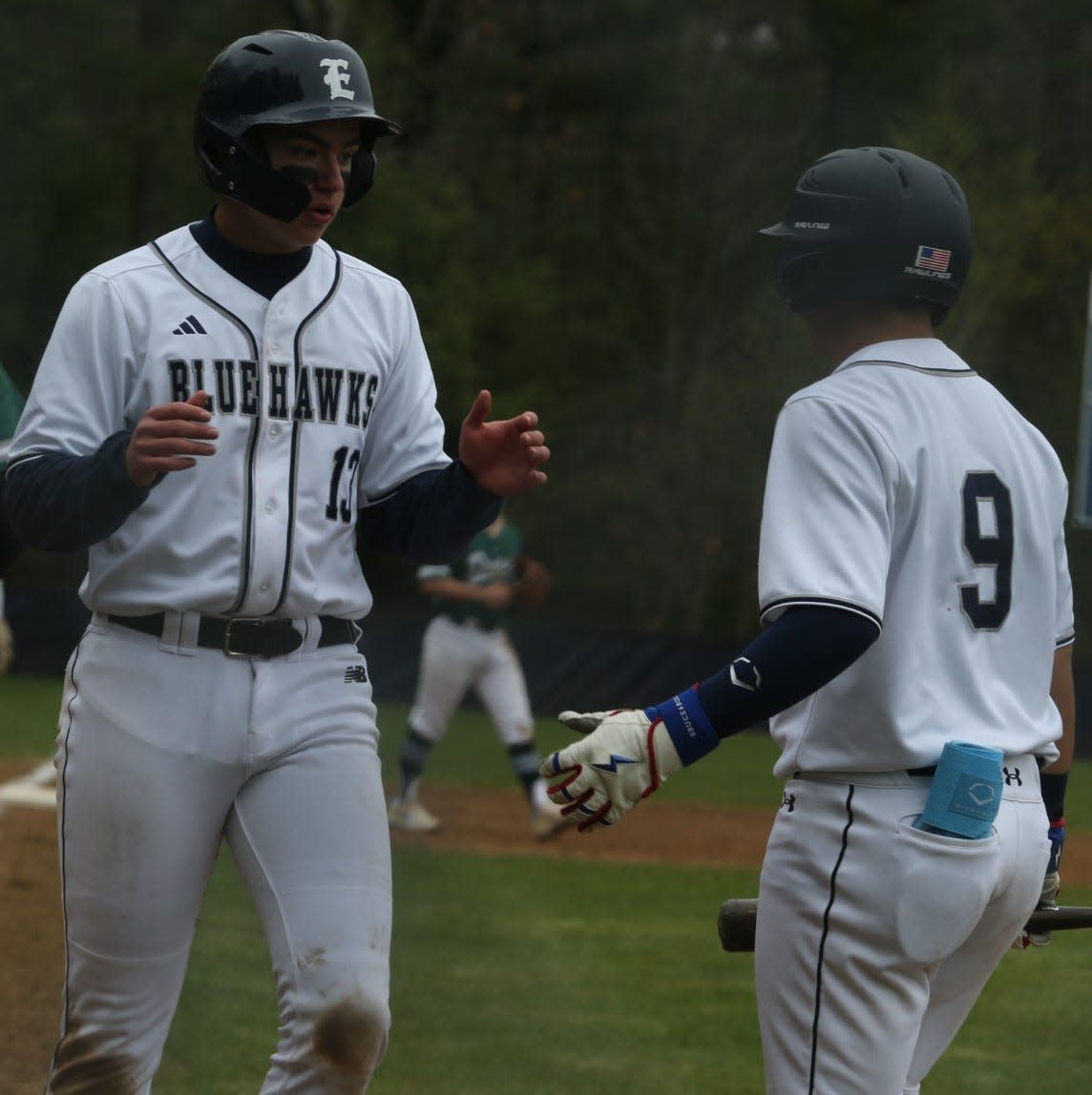 Exeter's Shea LaFleur (13) and Kyle Morgado (9) celebrate a run during Exeter's 5-1 win over Dover on Wednesday.