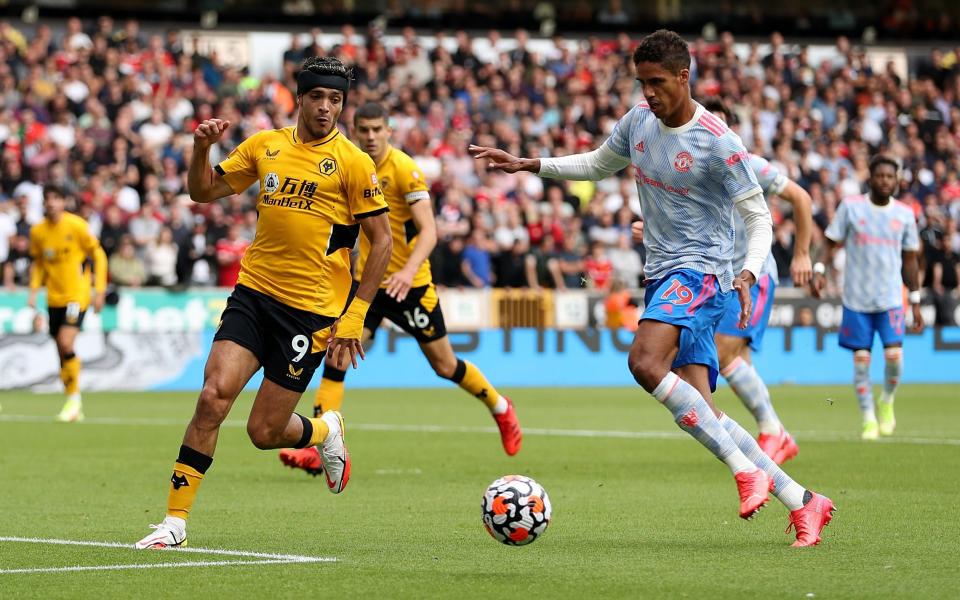 Raul Jimenez of Wolverhampton Wanderers battles for possession with RaphaÃ«l Varane of Manchester United during the Premier League match between Wolverhampton Wanderers and Manchester United at Molineux on August 29, 2021 in Wolverhampton, England - Wolverhampton Wanderers FC 
