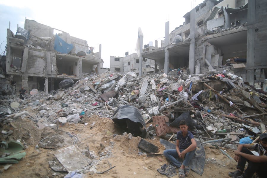 Palestinians isit by the rubble Abu Helal family in Rafah refugee camp, Gaza Strip, Monday, Oct. 9, 2023. The strike killed dozens of people.(AP Photo/Hatem Ali)