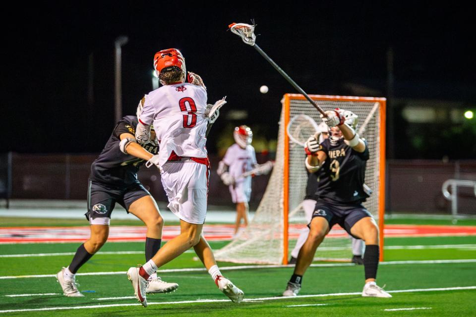 Vero Beach’s Tanner Lenhardt (3) scores the winning goal in overtime against No. 2 Viera in a high school lacrosse District 8-2A championship match at Vero Beach on Monday, April 15, 2024.